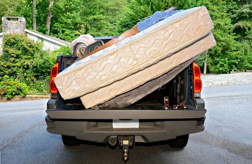 pickup truck carrying mattresses and carpets