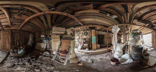 a messy storage site with ladders and old tires