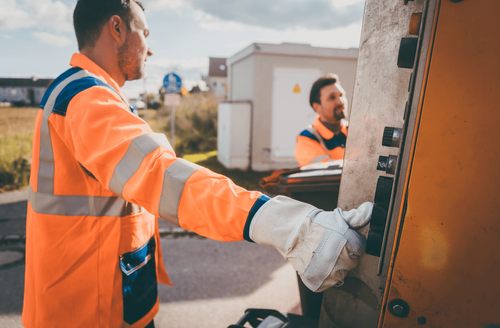 Two workers loading unwanted junks.
